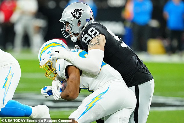 Crosby tackles Los Angeles Chargers with Austin Ekeler (30) in the first quarter