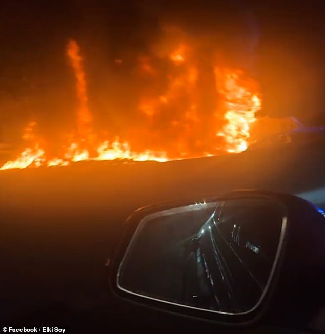 Cars on the highway at the time watched the plane burst into flames