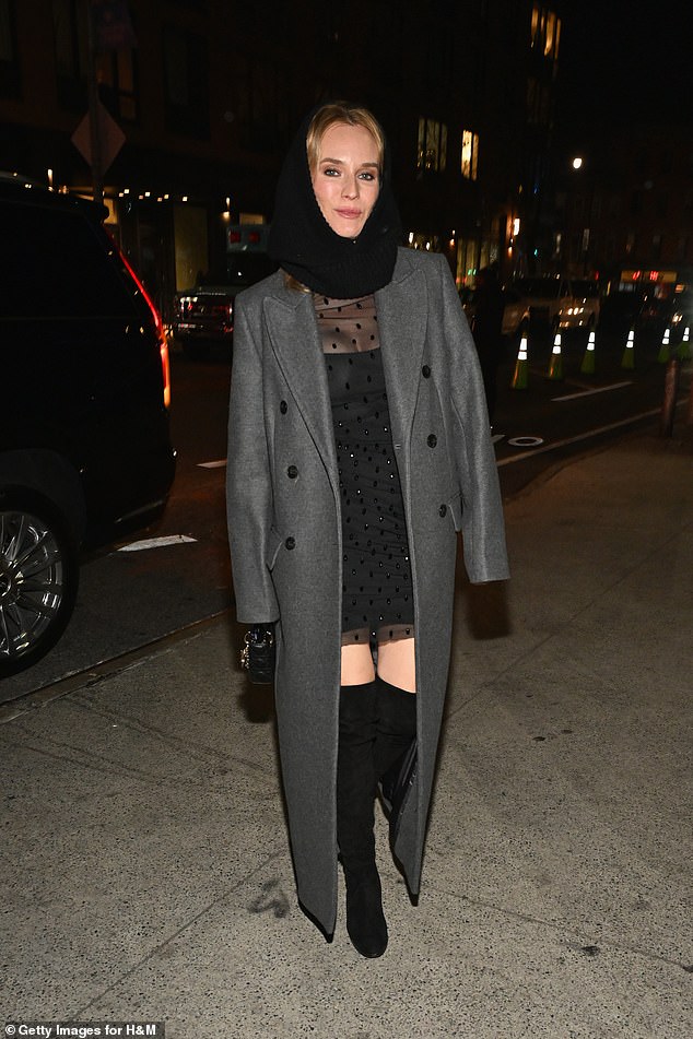 The German beauty bundled up against the cold as she arrived at the fashion event, wearing a gray coat and a black snood