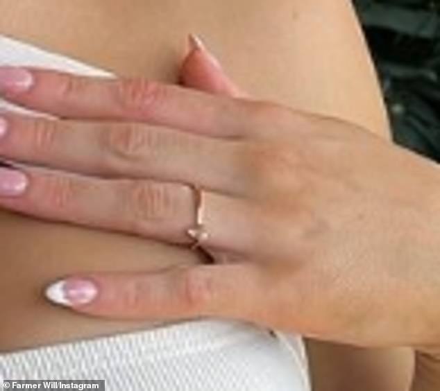 The Love Island star suggested her farmer boyfriend popped the question as she posed with her hand strategically placed on her chest as she showed off a possible engagement ring