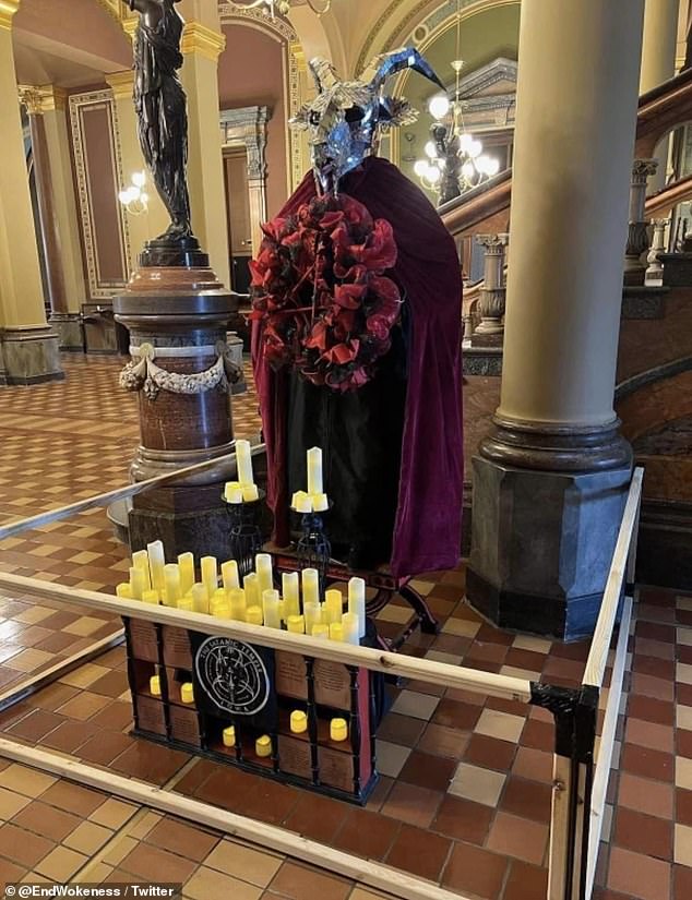 The exhibition featured a statue of Baphomet – a goat-headed figure used to represent Satan, along with the seven principles of Satanism, satanic symbols and many candles