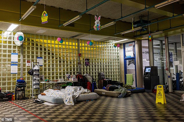 Asylum seekers sleep in the lobby of Chicago's District 5 police station