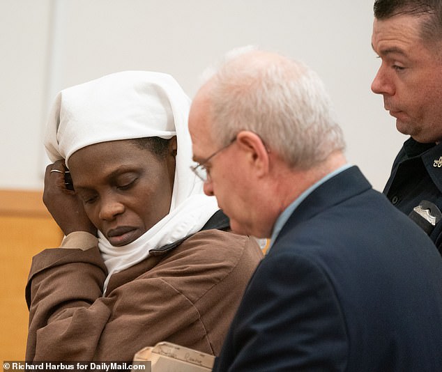 She was pictured in court wearing a head covering and a brown jumpsuit, hanging her head down as the sentencing began.