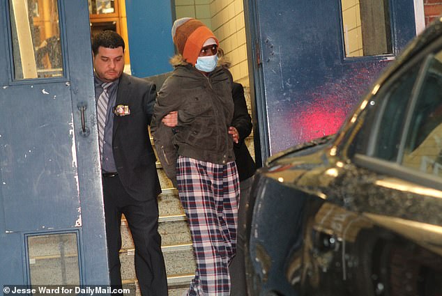 Shamaine Cato, 48, reportedly waited two hours to call 911 after her daughter Shalom Guifarro died Sunday.  In the photo: Cato is escorted by the police on Monday evening