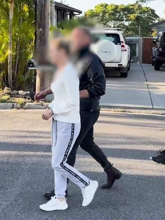 Ms Griffiths (white top, face blurred) spent two months in police custody after being arrested at her Umina Beach home.  Photo: NSW Police