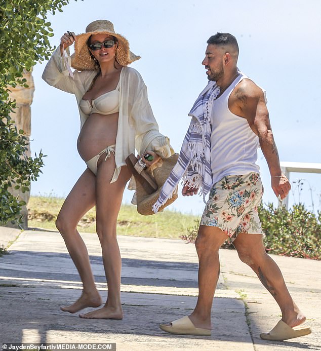 She had arrived earlier with boyfriend Jono, 32, and wore a loose, sheer cover-up over her swimwear and sunglasses