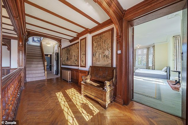 The property's decorative hallways feature wooden herringbone floors and beamed arches