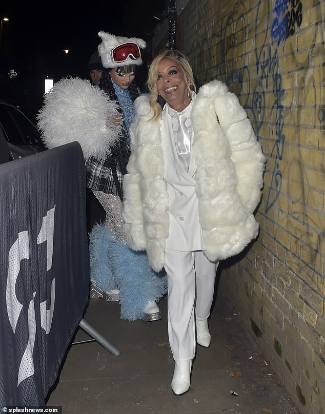 Norma wore an oversized white suit with a soft fur coat