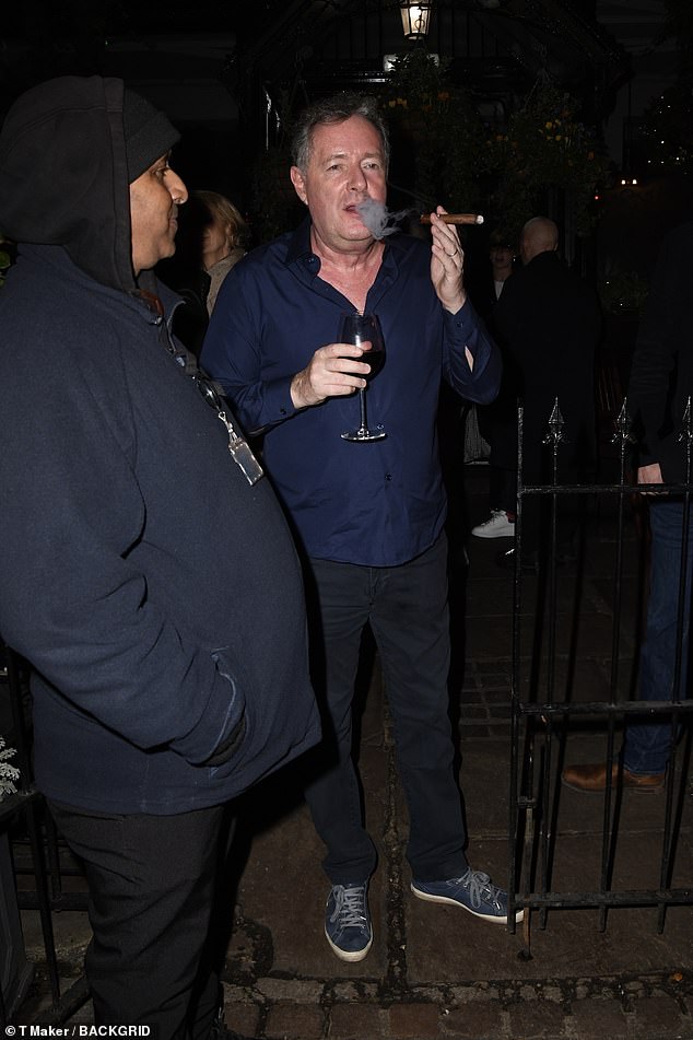 Piers cut a casual figure during the festivities as he donned a navy blue shirt and matching chinos