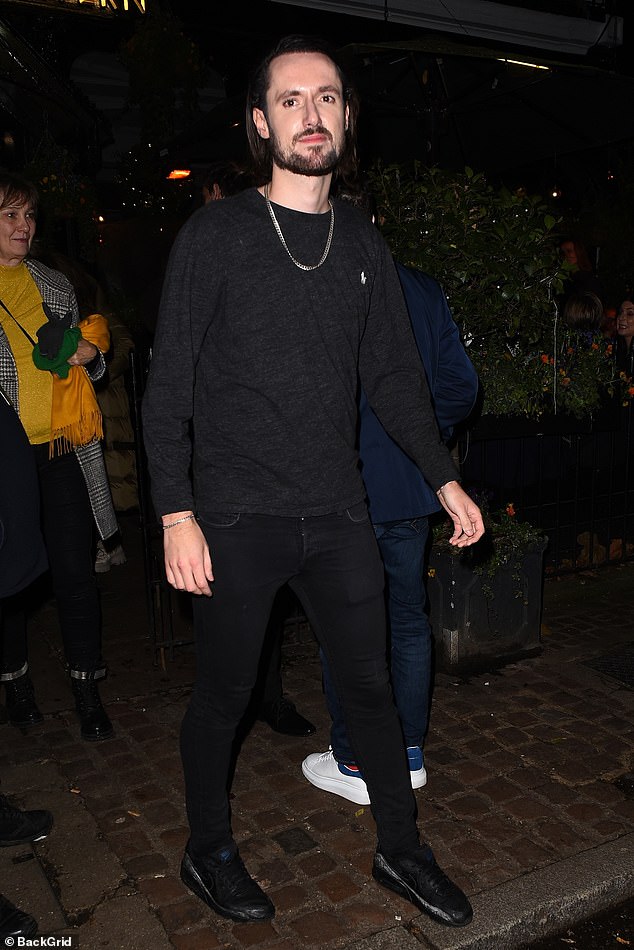 Piers' son Spencer Morgan wears an all-black outfit for the evening, wearing a lightweight jumper and jeans