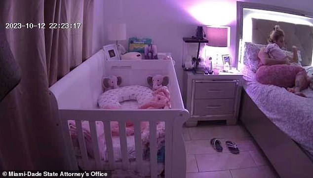 In another image released to the court, Irina Garcia is seen in bed at 10:23pm on the night of the murder, cradling her 14-day-old daughter.