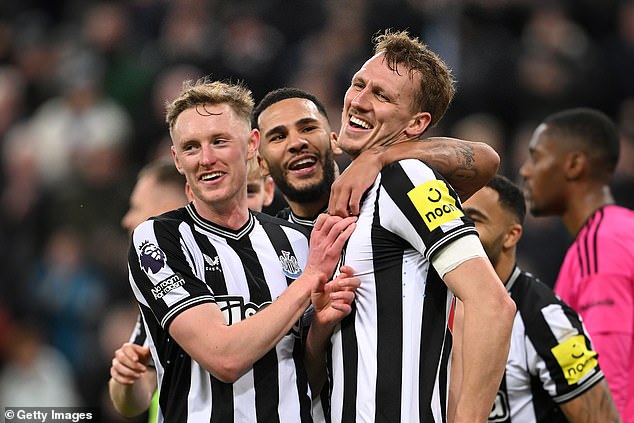 Dan Burn celebrates with Emil Krafth and Callum Wilson after wrapping up the match with the third goal