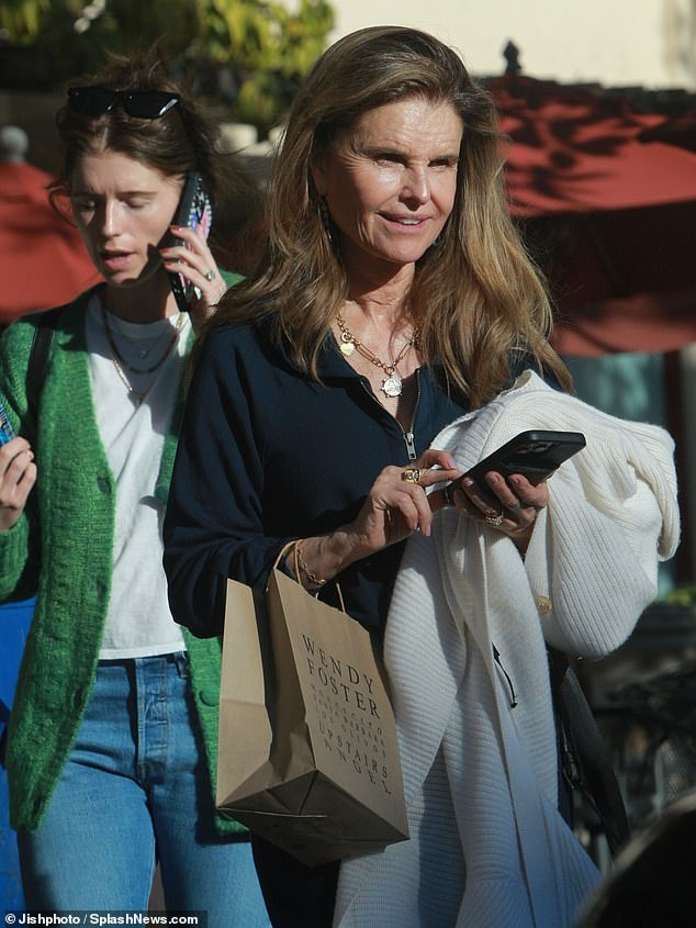 They both seemed glued to their iPhones, not losing a step in their search for that perfect holiday item.