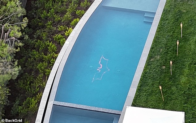 The Batman logo at the bottom of his pool is seen here in an aerial shot in daylight.  Perry's body was found in the hot tub next to the pool, at the bottom of this photo