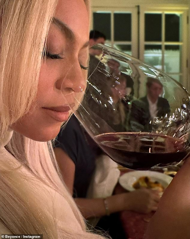 Beyonce also paused for a quick photo as she sipped a glass of red wine while sitting next to other guests at the long table.