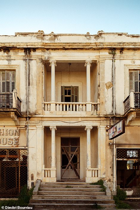 An abandoned house in Varosha, tightly closed 'to prevent intruders'.  Reflecting on the area's past, Dimitri added: 'Residents had to leave the area in a hurry in the 1970s.  They were never allowed to return'