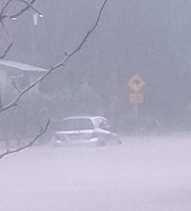 Queensland Fire and Emergency Services confirmed they are aware of the situation and are preparing water rescue crews and the helicopter pilot to locate and rescue the men (Photo: Clifton Beach experiencing severe flooding)