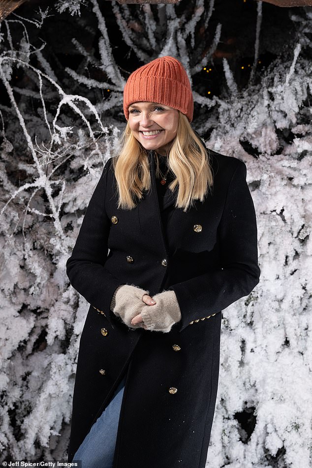 Baby Spice Emma beamed as she wore a black winter coat which she wore with blue jeans and an orange wool hat