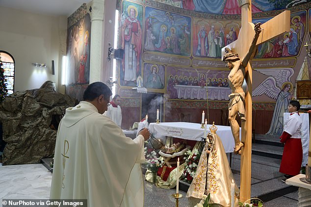 Palestinians visit the Roman Catholic Church of the Holy Family in Gaza City on Christmas Day, December 25, 2017