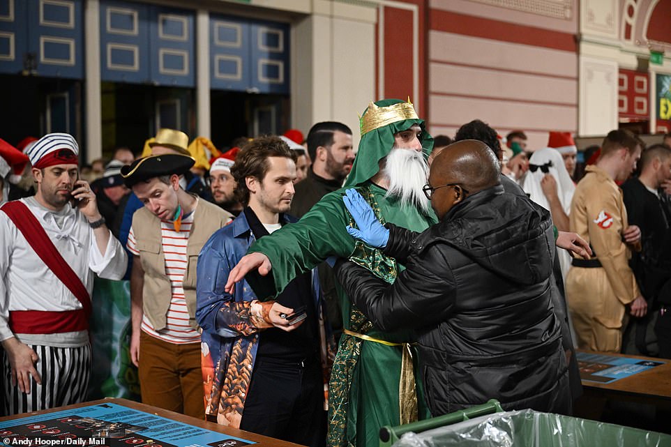 Outside the doors, lines of people adorned their costumes as guards conducted thorough checks