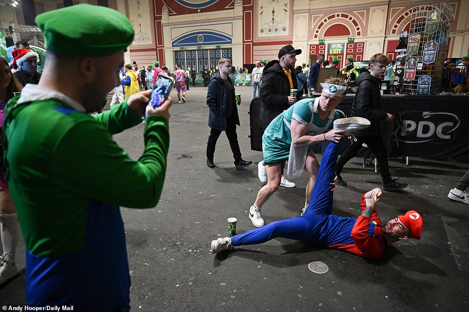 Two men dressed as a nurse and Mario respectively posed for a photo taken by another individual in a Luigi costume