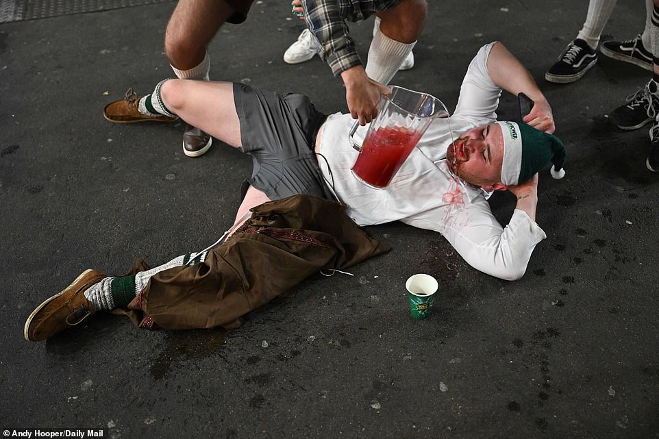 One man bizarrely had a cocktail poured over his white shirt as he lay on the floor in the room during the session