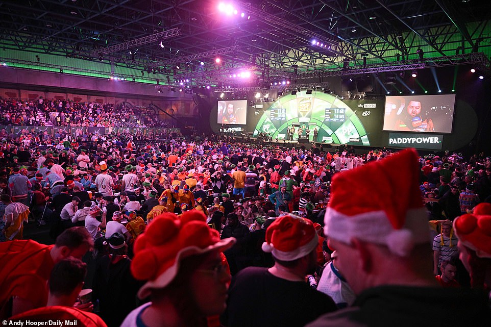 Michael Smith was spotted during his post-match interview with Sky Sports as the crowd chatted during the break