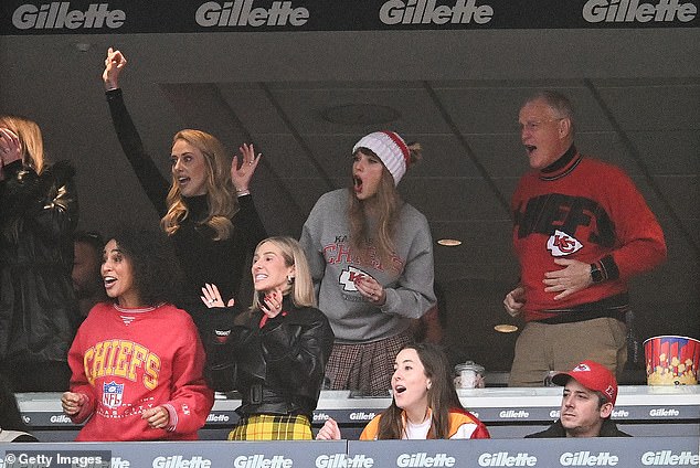 The Grammy winner was also joined by her father, Scott (above right), who wore a red and black Chiefs jersey despite being a fan of the Philadelphia Eagles.