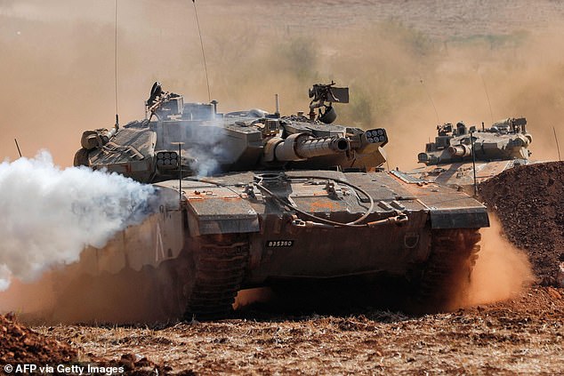 Israeli Merkava tanks take part in a military exercise near the border with Lebanon in the Upper Galilee region of northern Israel on October 24, 2023