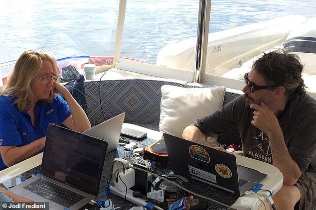 Dr. Brenda McCowan (left) and Dr. Fred Sharp played a pre-recorded hello call in the water as Twain approached their research vessel