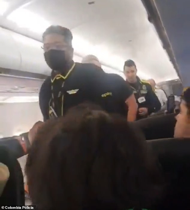 A Spirit Airlines crew member was escorting an unruly passenger before the flight was scheduled to depart Barranquilla, Colombia, on Sunday when the man suddenly lost his temper, swore at other passengers and got into a fistfight with police