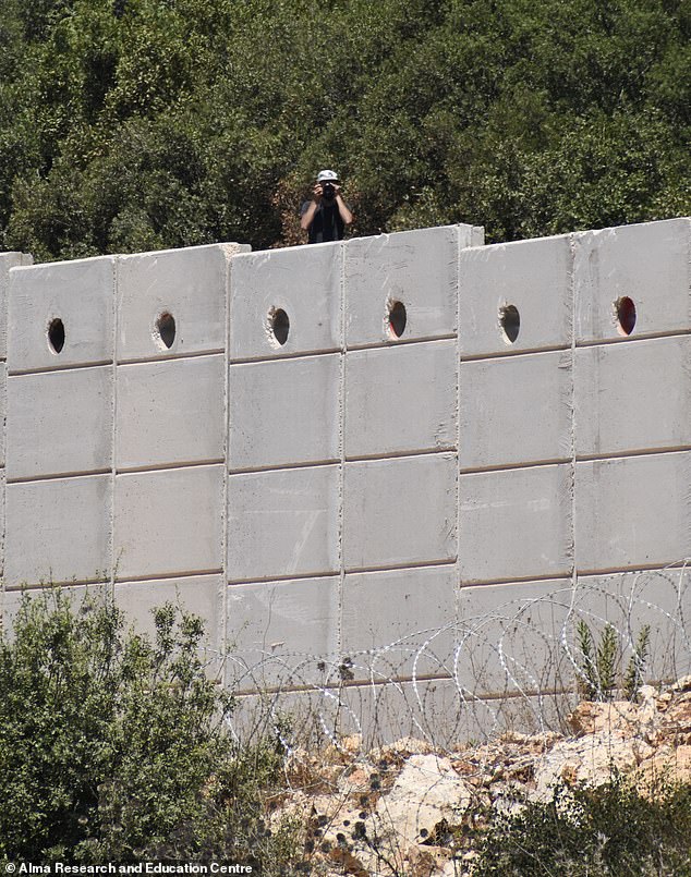 The photo shows Hezbollah soldiers spying near the Lebanese border with Israel