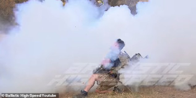 Adam staggers from the explosion as the smoke clears and he falls to the ground unconscious
