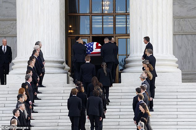 Former clerks of O'Connor line the steps of the Supreme Court as her casket is carried into the building to lie in repose Monday