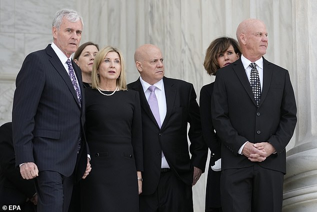 The deceased's sons, Scott O'Connor (left), Jay O'Connor (center) and Brian O'Connor (right) wait outside the Supreme Court building Monday for the arrival of their mother's casket.