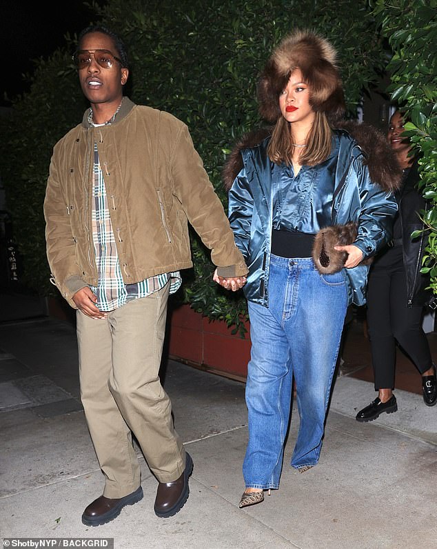 Rihanna wore a chic fur headscarf, a blue satin shirt, a matching jacket and a pair of faded denim