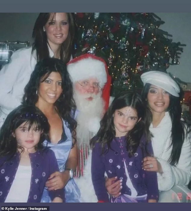 Another photo taken in the past shows a young Kylie taking a photo with Santa and her sisters Khloe, Kourtney, Kim and Kendall