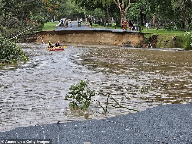 A main road has been divided in two due to heavy flooding in the aftermath of the former cyclone