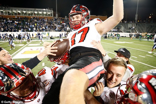 Field goal kicker Lucas Carneiro was carried off the field by his teammates after the victory