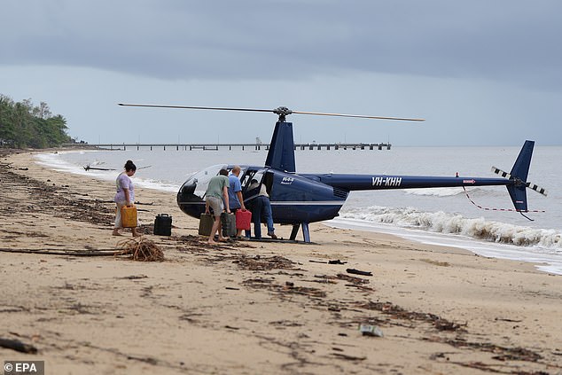 A helicopter is seen delivering fuel to residents of Wangetti Beach in Queensland