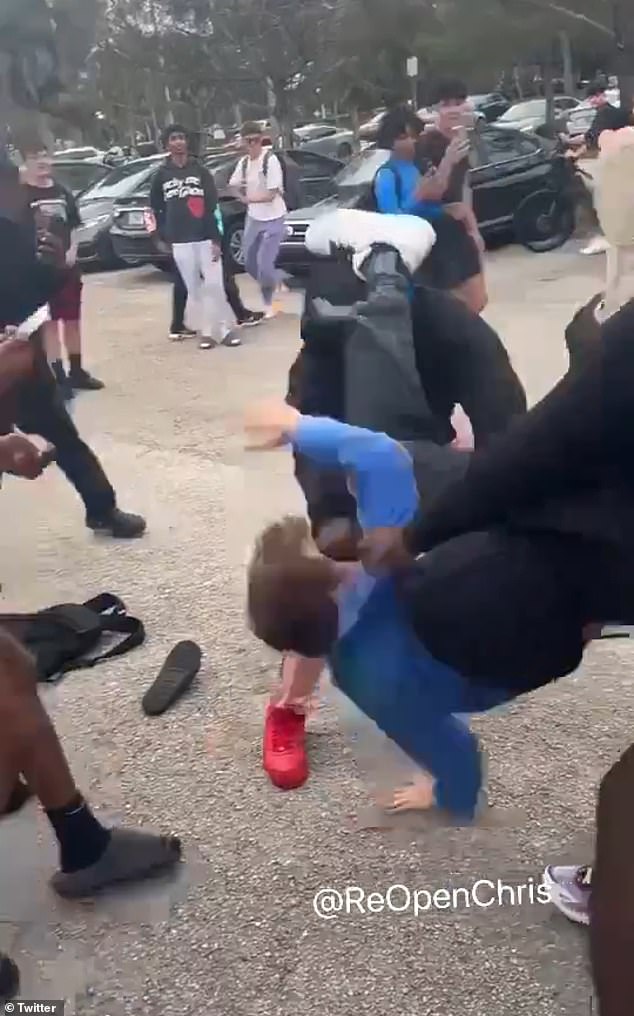 Video of the shocking fight shows a teenage boy carrying the victim over his shoulder before slamming his head into the concrete, knocking him unconscious