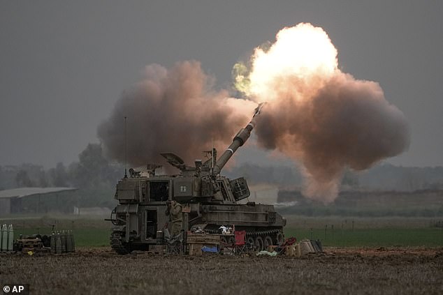 An Israeli mobile artillery unit fires a shell from southern Israel towards the Gaza Strip