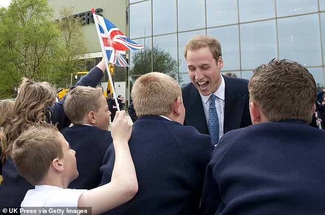 Prince William laughs with the crowd at JCB's headquarters in Rocester, Staffordshire, to mark the production of the company's 750,000th machine