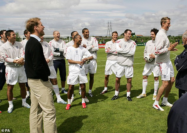 Prince William appears to be in hysterics as he watches Peter Crouch Peter perform his now famous goal celebration - the 'robot' - while the rest of England's World Cup squad also laughs, during a training session at Manchester United's Carrington training ground in 2006