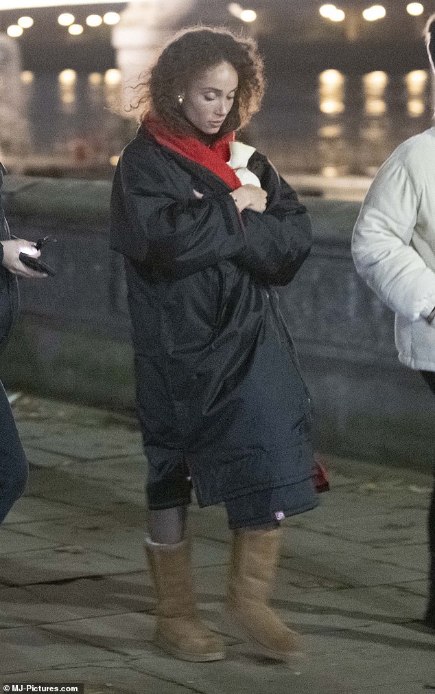 She later wrapped herself in a long winter coat and UGG boots after filming as she left the location with her crew