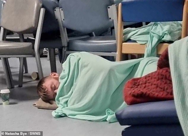 Steven Wells (pictured sleeping on the floor at William Harvey Hospital in Ashford, Kent) had to wait 45 hours in A&E after he started vomiting blood and was forced to sleep on the floor while he waited to be admitted