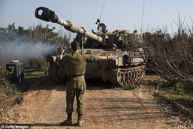 Pictured: An Israeli soldier leads an artillery unit near the border with Lebanon on December 19, 2023 on the northern border, Israel