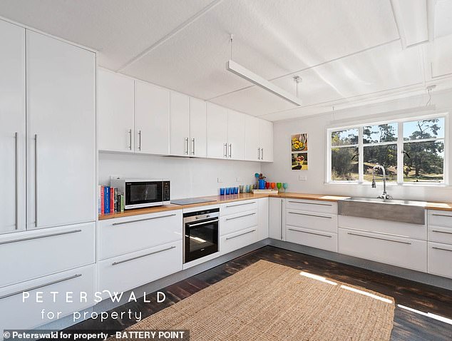 Inside there is a surprisingly large and modern kitchen with sleek wooden worktops and an industrial-quality sink