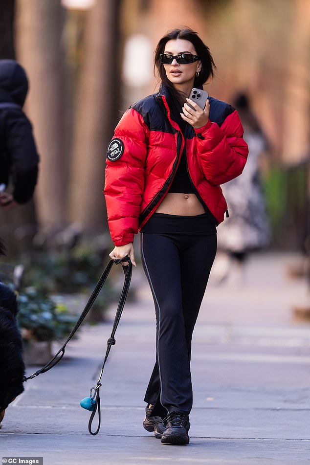 For her Tuesday outing, Emily chose a black high-neck crop top, paired with low-rise black fitted pants with a flared hemline