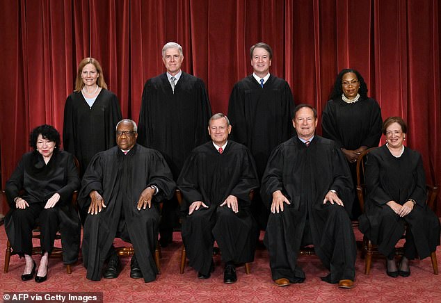 Robert (center) was sworn in as Chief Justice by Justice John Paul Stevens at the White House on September 29, 2005